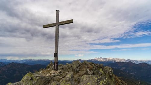 Looping Time Lapse Clouds Pass Over Mountain Summit Cross