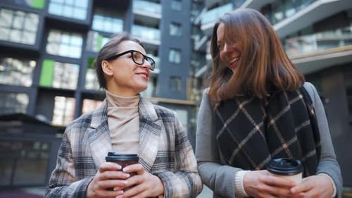 Two Women Laughing Together in the City