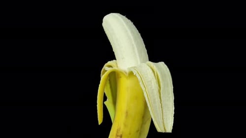 Rotating Peeled Banana on Black Background
