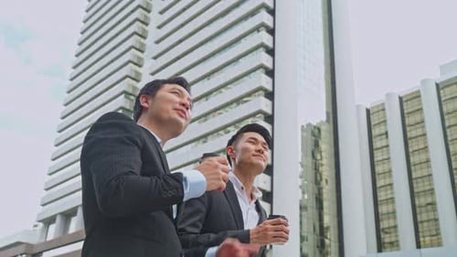 Asian young friend office business people hold cup of coffee and walk outdoor in city with confident