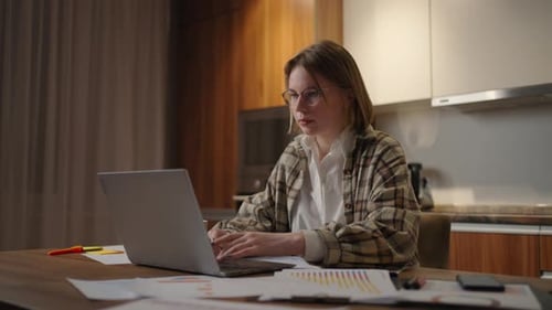 Woman Working at Laptop at Home