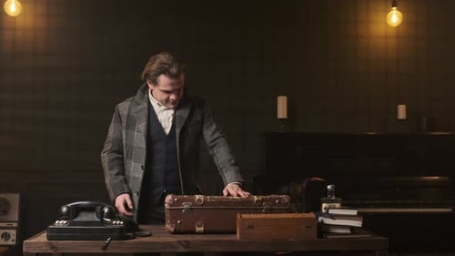 Man with Money Using Vintage Phone
