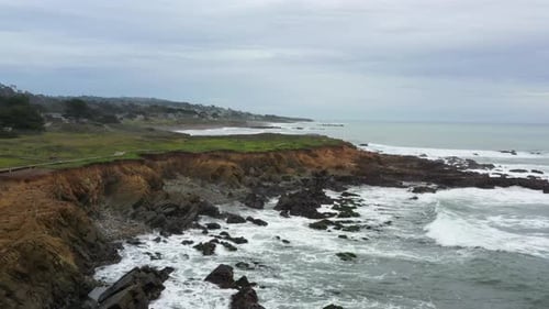 Flying Over Rocky Beach Shores of the California Coast Along Highway 1