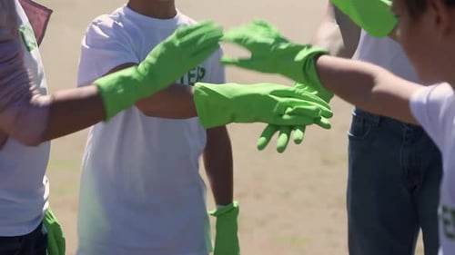 Volunteers Stacking Hands Together for Teamwork