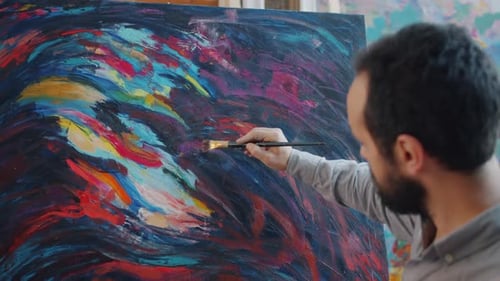 Artist Painting Abstract Design on Canvas