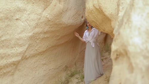 Asian Girl In Authentic Dress Between Orange Valley
