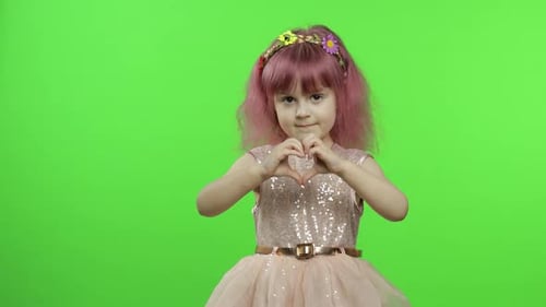 Young Girl Making Heart Shape with Hands