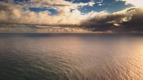 Golden Ocean at Sunrise with Dramatic Clouds