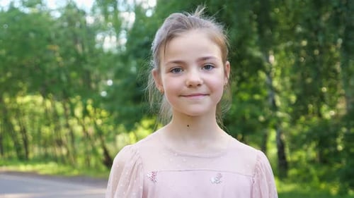 Girl Smiling and Giving Thumbs Up in Park