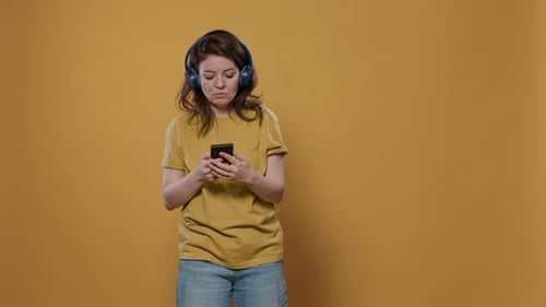 Woman Listening to Music on Phone with Headphones