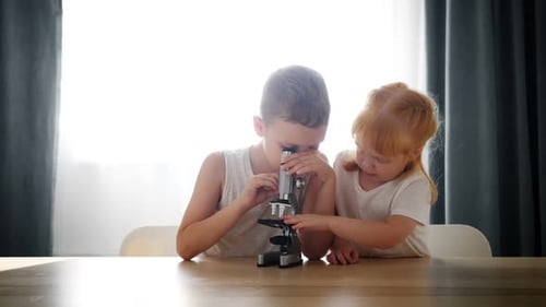 Children Explore with Microscope in Bright Home Environment