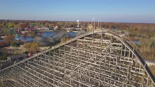 Aerial of rollercoaster and other rides at shut down amusement park
