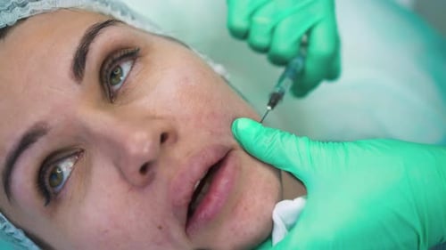 Cosmetologist in Protective Gloves Does Filler Injection