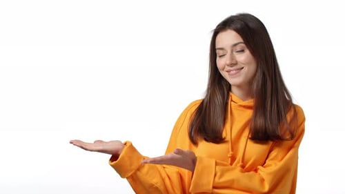 Slowmotion Adorable Cheeky Caucasian Woman in Stylish Hoodie Presenting Product Introduce Company