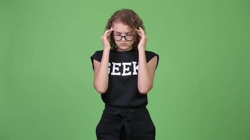 Young Person With Curly Hair Rubbing Temples