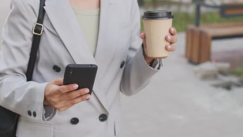 Midsection of Businesswoman Walking down Street