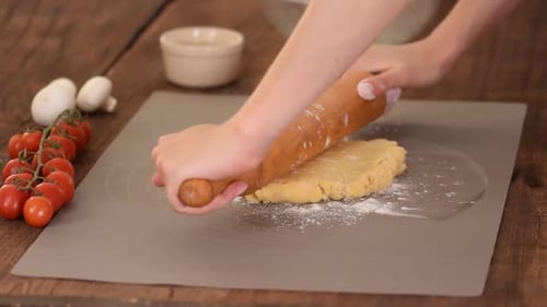 The Dough Rolling the Women's Hands.