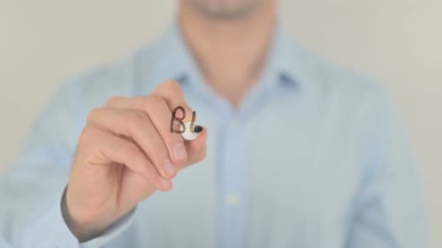 Adult Writing Phrase 'Be the Change' On Glass