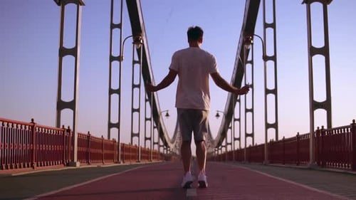 Male Athlete Jumps on the Bridge
