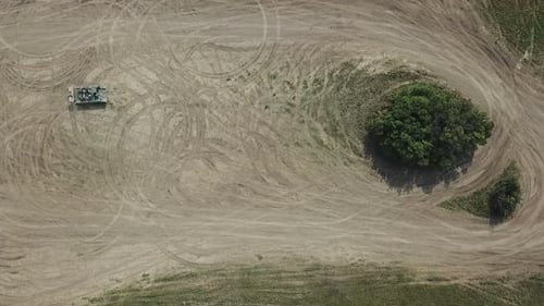 Tank Driving Across Dirt Field, Aerial View