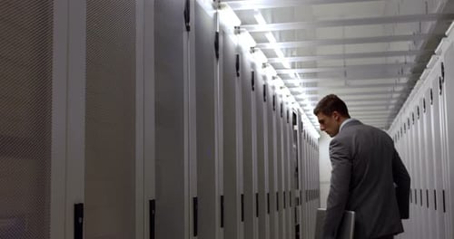 Data Technician Walking through Locker Hall