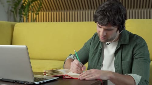 Young Adult Attends Remote Meeting and Takes Notes