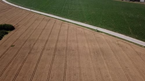 Aerial View of Highway Road Between Meadow and Agricultural Field.