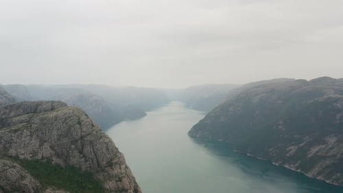 Backward Tracking Shot From a View of a Lake in the Middle of Mountains