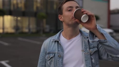 Smiling Man Holding Takeaway Coffee in City