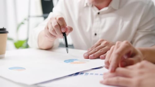 Man Points to Graph During Office Meeting