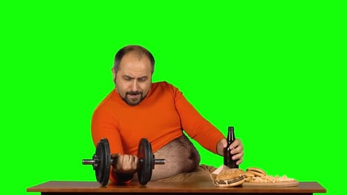 Adult Man Lifts Weights, Eats Junk Food