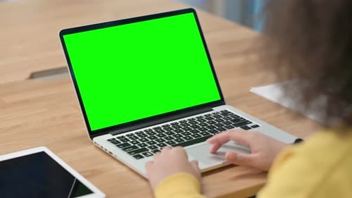 African Businesswoman Using Laptop with Green Chroma Key Screen