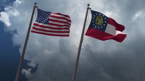 United States and Georgia Flags Waving in Cloudy Sky