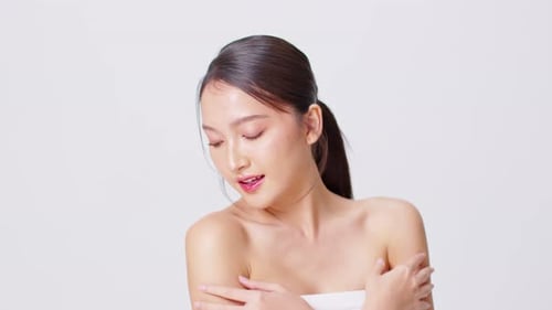Attractive Woman with Bare Shoulders Posing in Studio