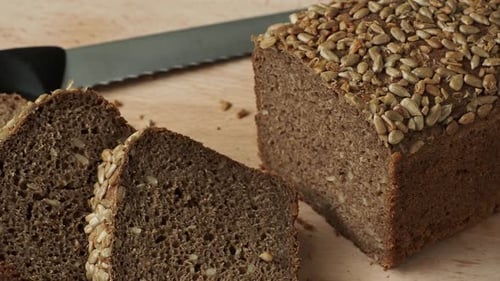 Dark Seeded Loaf of Bread on Cutting Board