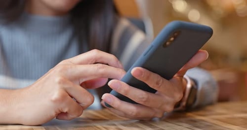 Woman use of mobile phone in restaurant