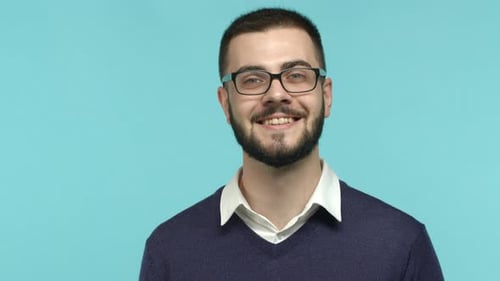 Close Up of Smiling Brunette Male Office Worker in Glasses Looking Happy at Camera Standing Against