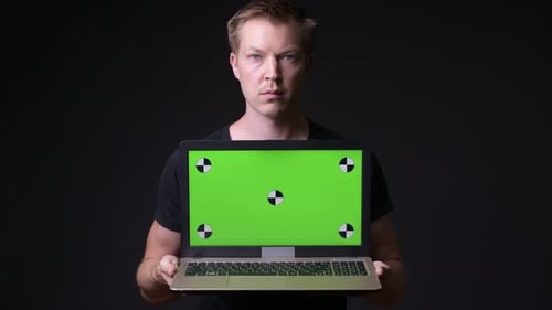 Young Handsome Man Using Laptop with Green Screen Chroma Key