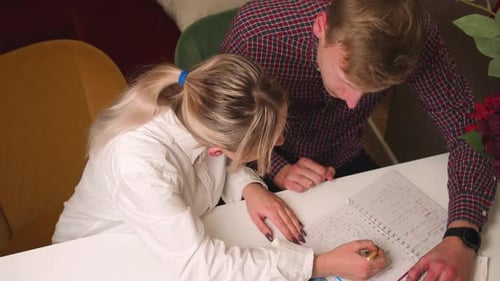 Close Up Young Man and Woman Study at Home Students Teach Notes Man and Woman Tutor at Home with