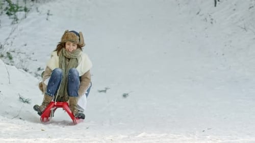 Woman and Boy Sledding in Winter