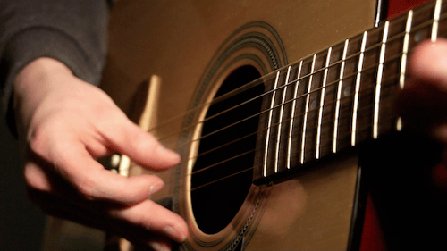 Close Up of Guitar Being Strummed