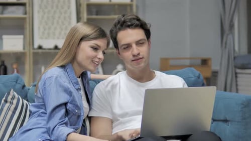 Young Couple Using Laptop Together at Home