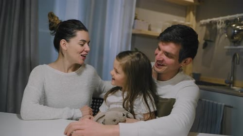 Loving Family Talking and Laughing Together at Home