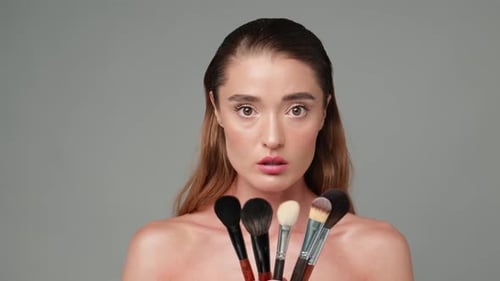Woman Demonstrates Cosmetic Makeup Brushes for Tutorial