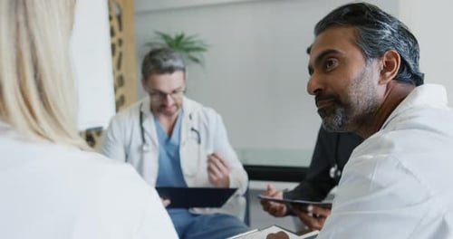 Doctors Meeting at Conference Table in Hospital