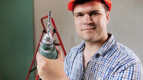 Construction Worker Holding Drill, Indoor Setting