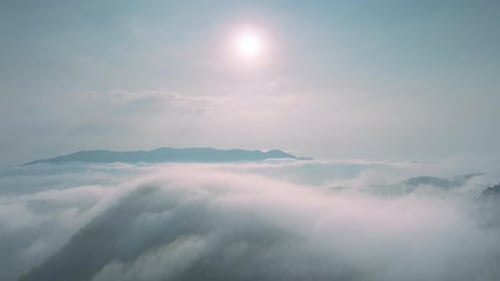 Aerial view The morning fog in the forest and mountains and the transmission towers.