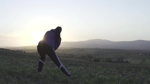 A young woman stretching.