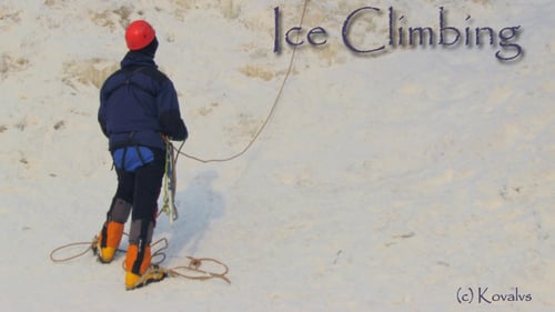 Climber Prepares to Ice Climb Snowy Mountain