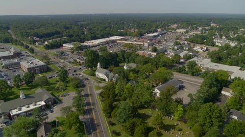Forward Aerial Pan of a Small Town Amongst Trees in Smithtown Long Island